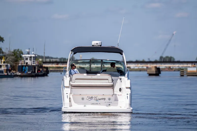 Yacht Photos Pics 2017 Regal 32 Express boat cruising on a calm waterway.