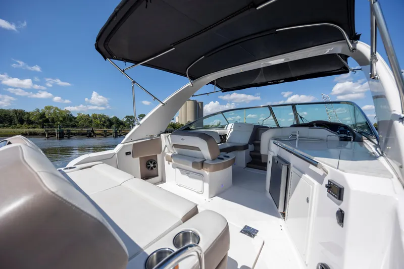  Yacht Photos Pics 2017 Regal 32 Express boat interior with seating, canopy, and water view.