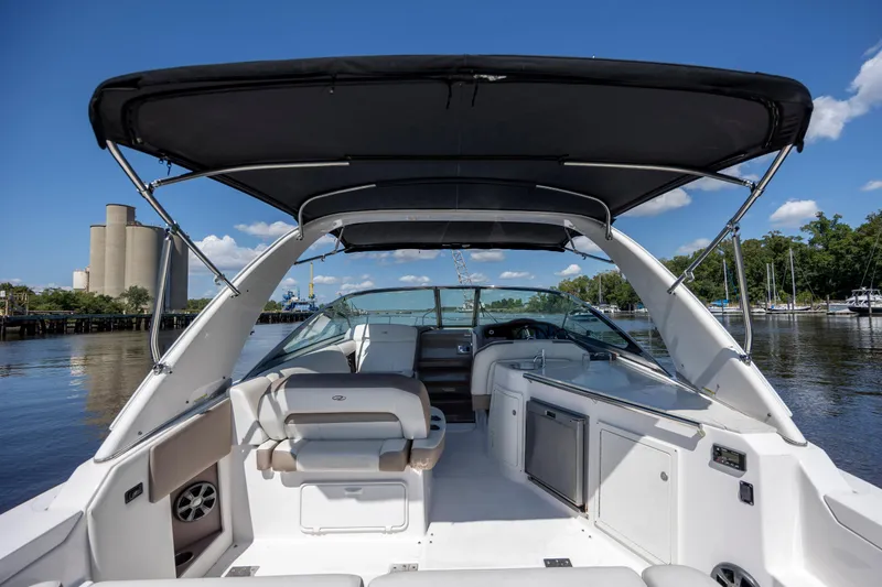  Yacht Photos Pics 2017 Regal 32 Express boat interior with canopy, docked on a sunny day.