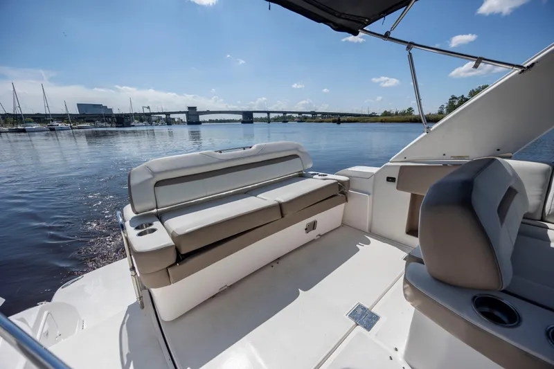  Yacht Photos Pics 2017 Regal 32 Express boat interior with seating, cup holders, and scenic water view.