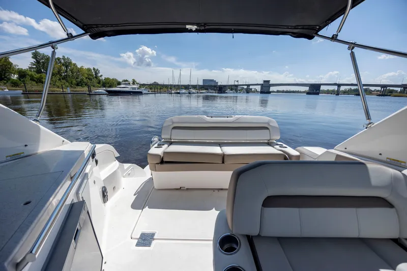  Yacht Photos Pics 2017 Regal 32 Express boat interior with seating, overlooking a serene waterfront view.