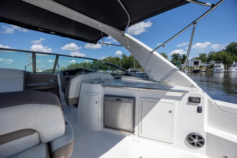 Yacht Photos Pics 2017 Regal 32 Express boat interior with seating, kitchenette, and water view.