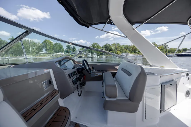  Yacht Photos Pics 2017 Regal 32 Express boat interior with helm, seating, and water view.