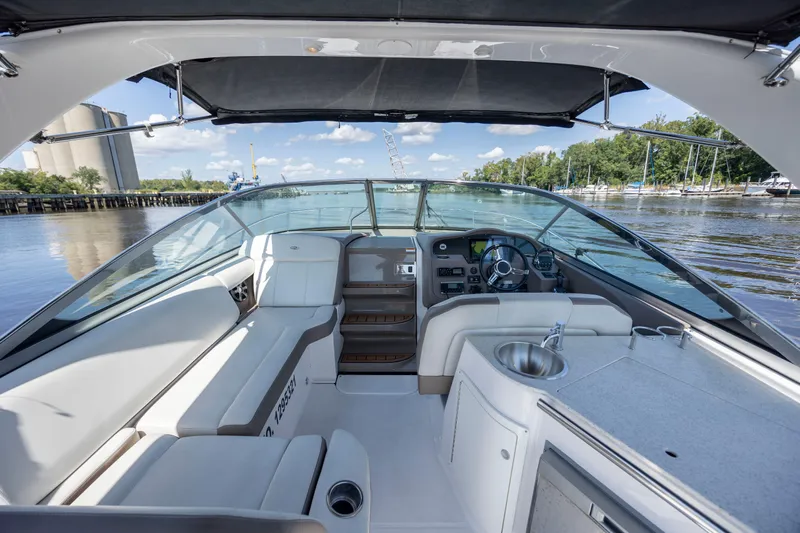  Yacht Photos Pics 2017 Regal 32 Express boat interior with helm, seating, and kitchenette on a sunny day.