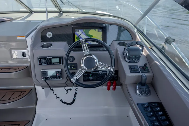  Yacht Photos Pics Cockpit of 2017 Regal 32 Express boat with steering wheel and navigation controls.