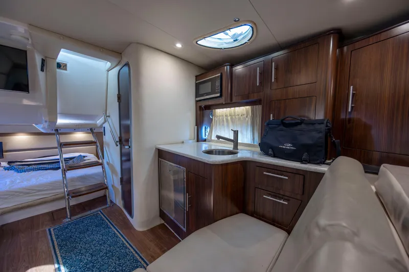  Yacht Photos Pics Luxurious interior of 2017 Regal 32 Express yacht with kitchenette and sleeping area.