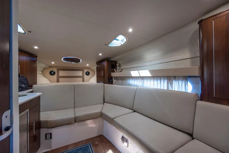  Yacht Photos Pics Interior of 2017 Regal 32 Express yacht with beige seating and wooden cabinets.