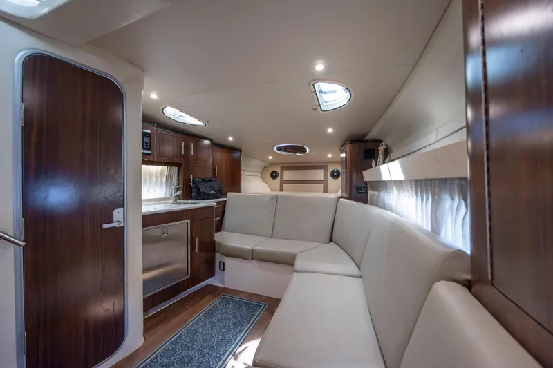  Yacht Photos Pics Luxurious interior of 2017 Regal 32 Express yacht with modern kitchen and seating area.