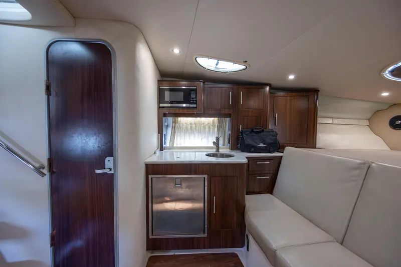  Yacht Photos Pics 2017 Regal 32 Express yacht interior with kitchenette, microwave, and seating area.