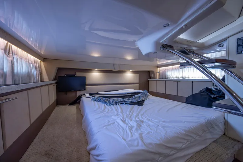  Yacht Photos Pics Luxurious interior cabin of a 2017 Regal 32 Express yacht with bed and TV.