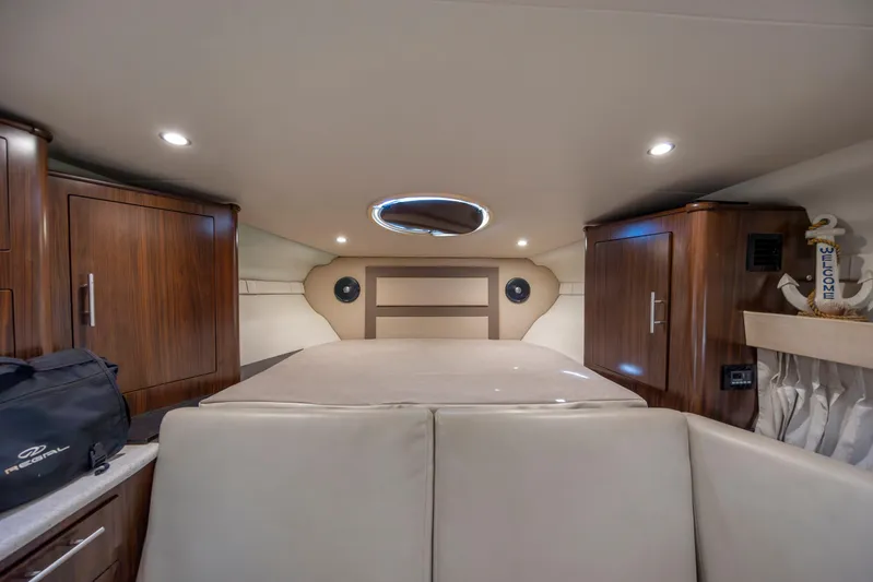  Yacht Photos Pics Interior cabin of 2017 Regal 32 Express boat with wood cabinets and cozy seating.