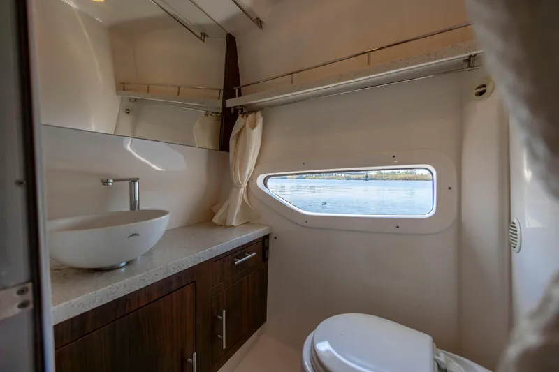  Yacht Photos Pics Luxurious bathroom interior of 2017 Regal 32 Express yacht with window view.