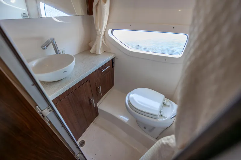  Yacht Photos Pics 2017 Regal 32 Express yacht bathroom with sink, toilet, and window view.