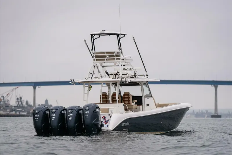 Mad Hatter Yacht Photos Pics 2019 Everglades 435 Center Console boat with four outboard engines on water.