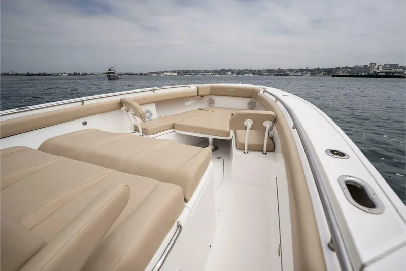 Mad Hatter Yacht Photos Pics 2019 Everglades 435 Center Console boat with beige seating on calm water.