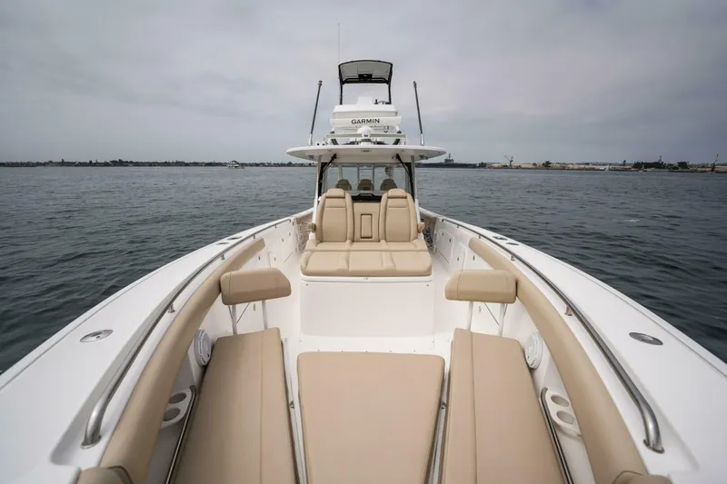 Mad Hatter Yacht Photos Pics 2019 Everglades 435 Center Console boat with spacious seating on calm waters.