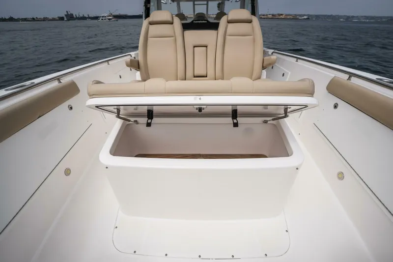 Mad Hatter Yacht Photos Pics 2019 Everglades 435 Center Console boat with open storage compartment and beige seating.