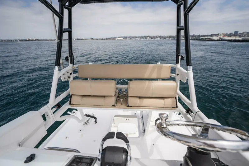 Mad Hatter Yacht Photos Pics 2019 Everglades 435 Center Console boat interior with beige seating and ocean view.