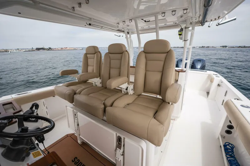 Mad Hatter Yacht Photos Pics 2019 Everglades 435 Center Console boat with beige leather seats on open water.