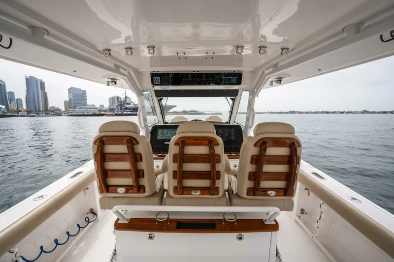 Mad Hatter Yacht Photos Pics 2019 Everglades 435 Center Console boat interior with city skyline in background.