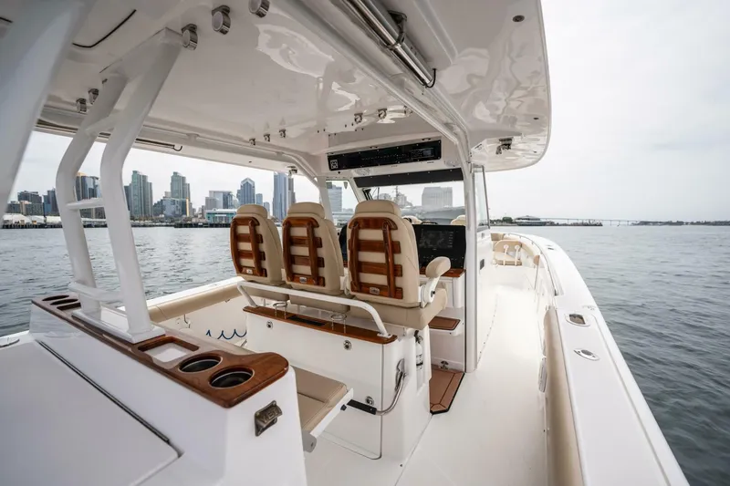 Mad Hatter Yacht Photos Pics 2019 Everglades 435 Center Console boat interior with city skyline in background.