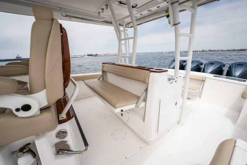 Mad Hatter Yacht Photos Pics 2019 Everglades 435 Center Console boat interior with beige seating and ocean view.
