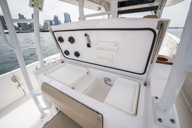 Mad Hatter Yacht Photos Pics 2019 Everglades 435 Center Console boat with open storage compartments and city skyline in background.