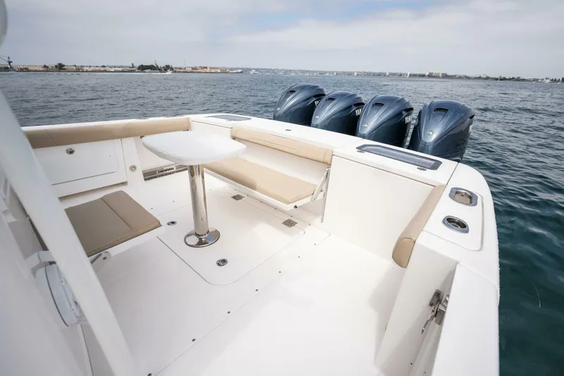 Mad Hatter Yacht Photos Pics 2019 Everglades 435 Center Console boat with seating and four outboard engines.