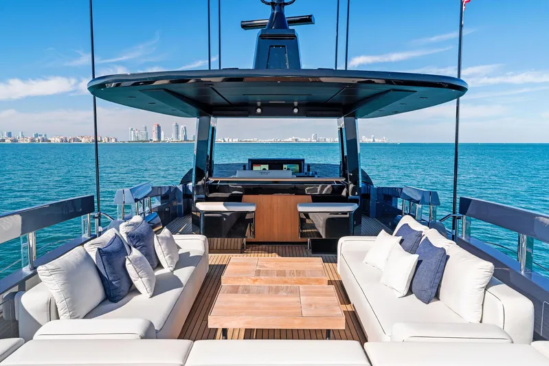 Caffeine Yacht Photos Pics Luxurious 2023 Pershing GTX 116 yacht deck with elegant seating and ocean view.
