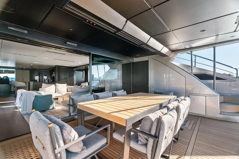 Caffeine Yacht Photos Pics Luxurious 2023 Pershing GTX 116 yacht interior with elegant dining area and modern furnishings.