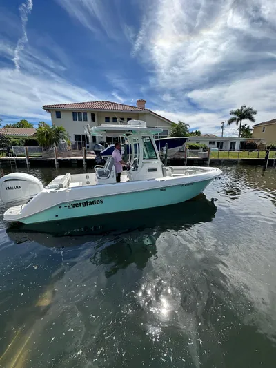  Yacht Photos Pics 2023 Everglades 235 boat on a sunny day near waterfront homes.
