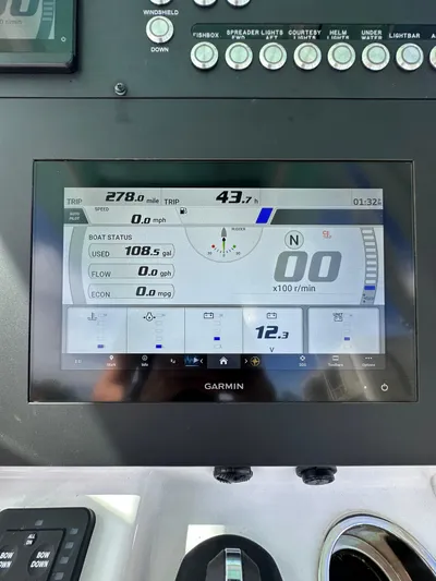  Yacht Photos Pics 2023 Everglades 235 boat dashboard with Garmin display showing speed and fuel data.