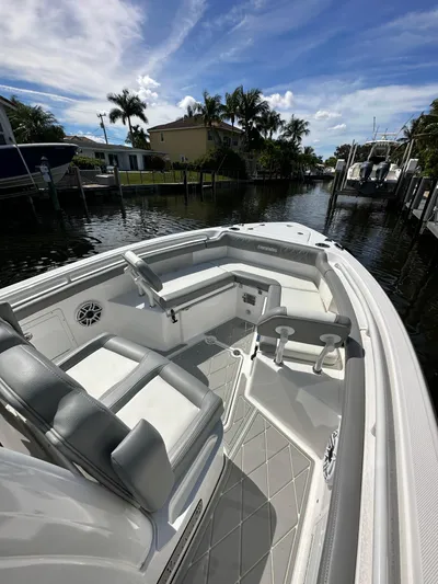  Yacht Photos Pics 2023 Everglades 235 boat interior with seating, docked in a canal.