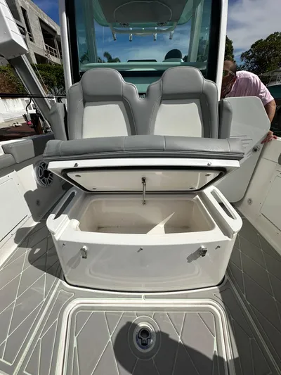  Yacht Photos Pics 2023 Everglades 235 boat with open storage compartment and dual seats.