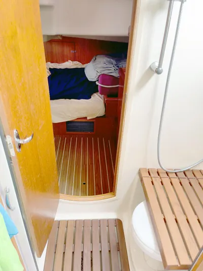 Wild Card Yacht Photos Pics Interior of 2005 Hunter 38 sailboat showing cabin and bathroom with wooden flooring.