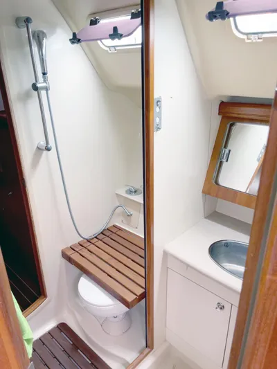 Wild Card Yacht Photos Pics Compact bathroom in a 2005 Hunter 38 sailboat with shower, toilet, and sink.