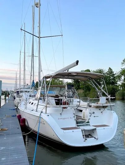 Wild Card Yacht Photos Pics 2005 Hunter 38 sailboat docked in serene marina setting.