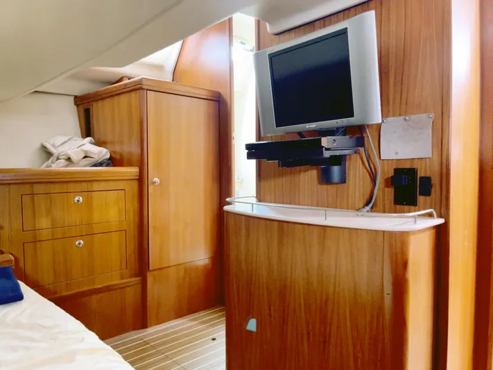 Wild Card Yacht Photos Pics Interior of 2005 Hunter 38 yacht with wood cabinetry and mounted TV.