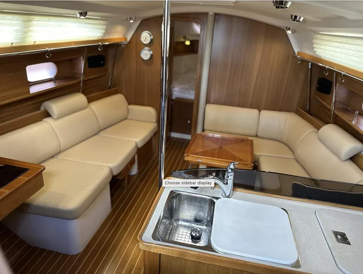 Sea Urchin Yacht Photos Pics Luxurious interior of a 2013 Catalina 355 sailboat with elegant seating and wood finishes.