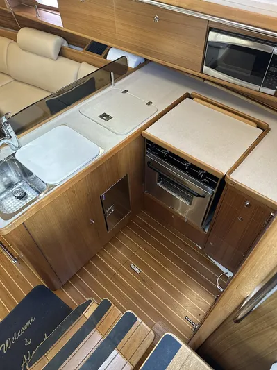 Sea Urchin Yacht Photos Pics 2013 Catalina 355 yacht interior with modern kitchen, featuring wood cabinetry and stainless steel appliances.