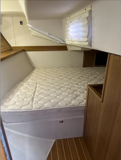 Sea Urchin Yacht Photos Pics 2013 Catalina 355 yacht cabin with a cozy bed and wooden interior.