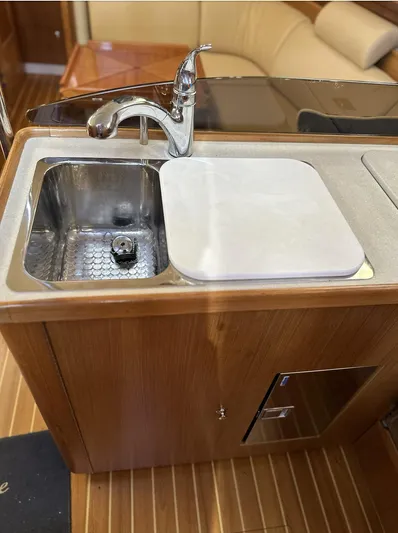 Sea Urchin Yacht Photos Pics 2013 Catalina 355 yacht kitchen sink with wooden cabinetry and modern faucet.