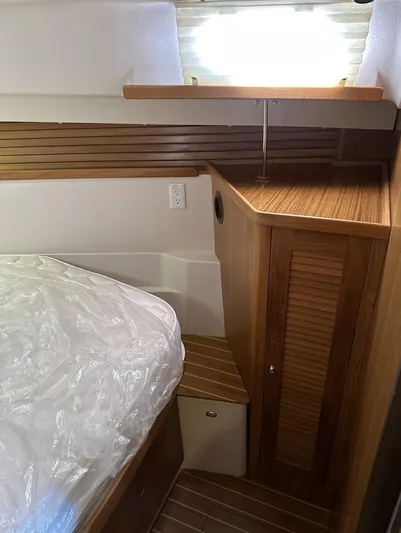 Sea Urchin Yacht Photos Pics Interior cabin of a 2013 Catalina 355 sailboat with wooden cabinetry and bed.