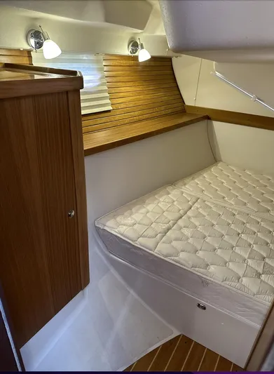 Sea Urchin Yacht Photos Pics 2013 Catalina 355 yacht interior with cozy cabin bed and wooden accents.