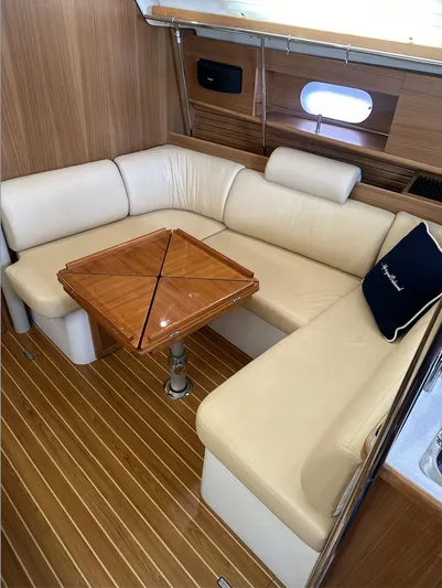 Sea Urchin Yacht Photos Pics 2013 Catalina 355 yacht interior with beige seating and wooden table.