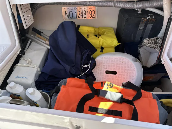 Sea Urchin Yacht Photos Pics Storage compartment of a 2013 Catalina 355 sailboat with life jackets and boating gear.