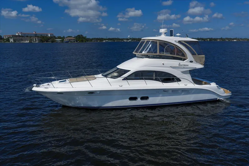 Vivid Imagination Yacht Photos Pics 2007 Sea Ray 52 Sedan Bridge yacht on calm water under a blue sky.