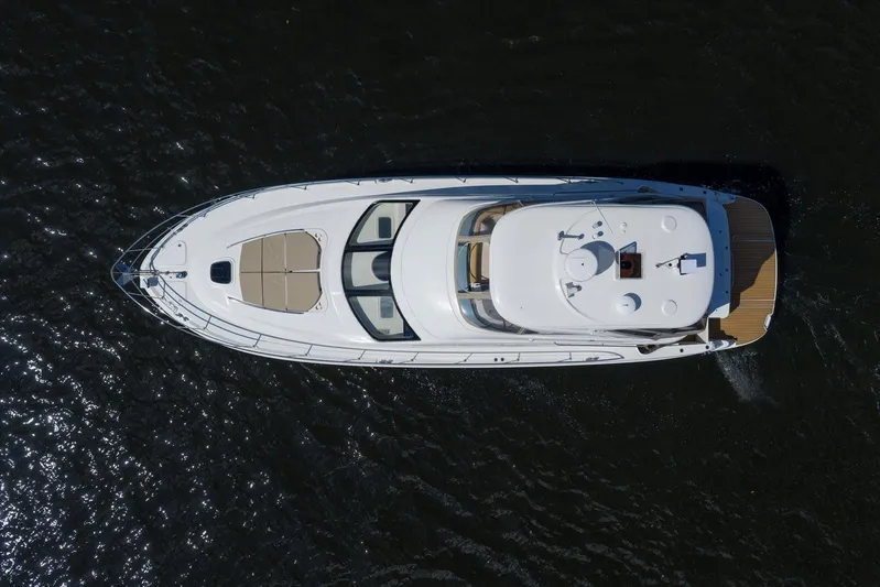 Vivid Imagination Yacht Photos Pics Aerial view of 2007 Sea Ray 52 Sedan Bridge yacht on dark water.