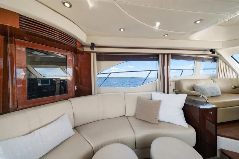 Vivid Imagination Yacht Photos Pics Luxurious interior of 2007 Sea Ray 52 Sedan Bridge yacht with elegant seating and ocean view.