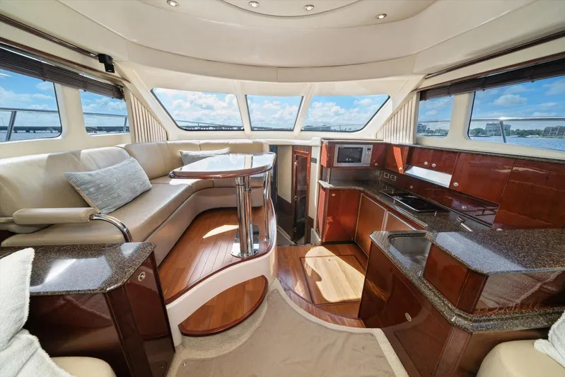 Vivid Imagination Yacht Photos Pics Luxurious interior of 2007 Sea Ray 52 Sedan Bridge yacht with modern kitchen and seating area.